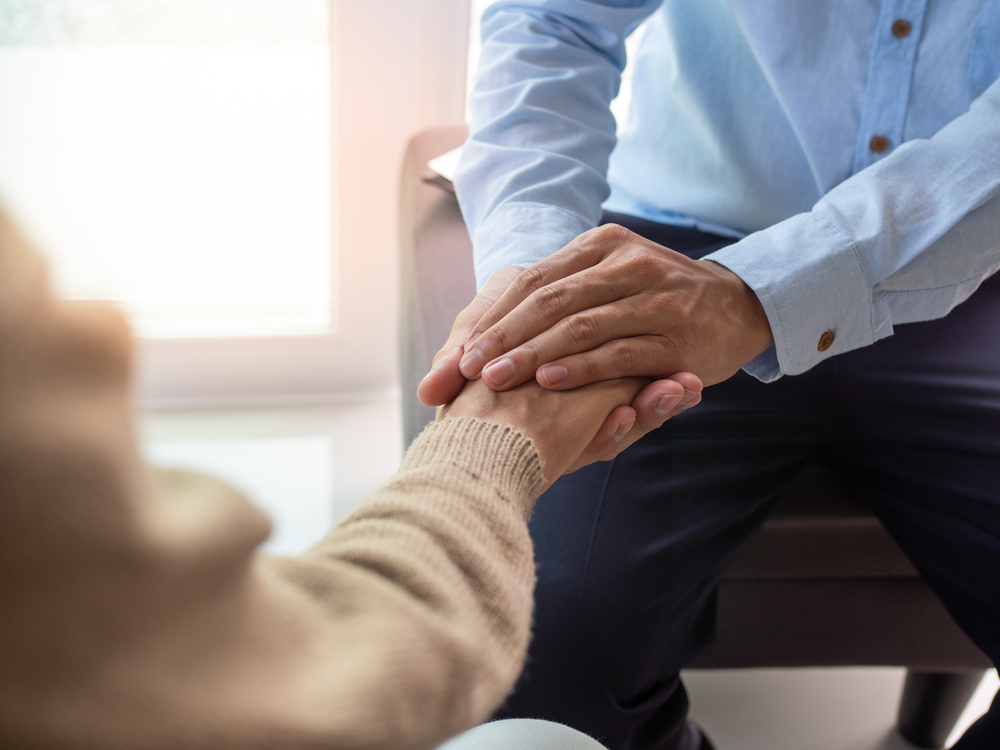 doctor holding patient's hand