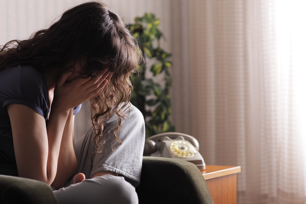 frustrated woman with head in hands